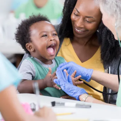 Nurse Taking Care of a Happy Baby