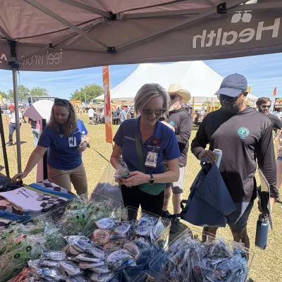 (From L-R) AdventHealth Sebring/Wauchula/Lake Placid Chief Medical Officer Dr. Victoria Selley and AdventHealth Wauchula Vice President and Administrator Christen Johnson were among the team members handing out items to attendees at Sebring International Raceway.