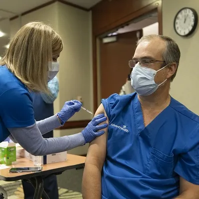 Dr. Oliveira receives a COVID-19 Vaccination at AdventHealth Orlando