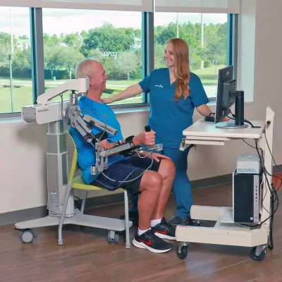 A Provider Helps a Patient with Neurological Physical Therapy