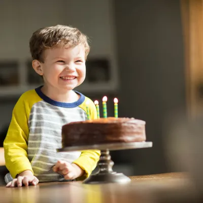 Child excited for his birthday cake