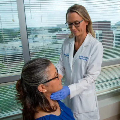 Dr. Cory O'Brien checking patient's throat at AdventHealth Digestive Health Institute Tampa.