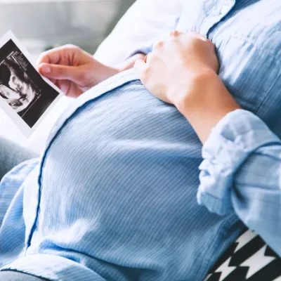 Pregnant woman looking at a picture.