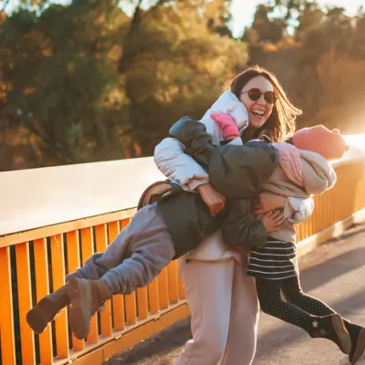 family-embracing-on-bridge-outdoors