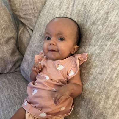 AdventHealth for Children Fetal Cardiology patient Laelynn propped up on a couch.