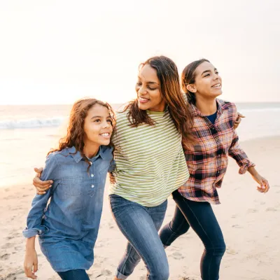 Mother and Daughters Walking on the Beach