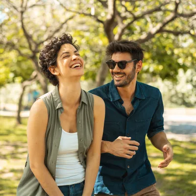 Young happy couple walking together in the park