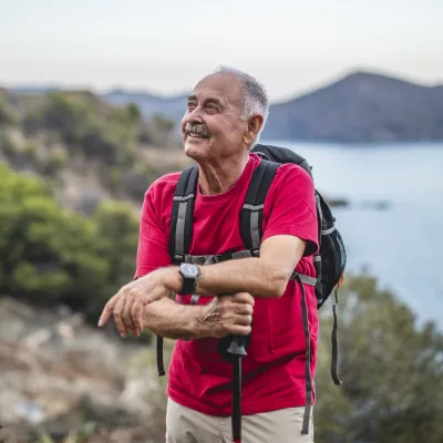 Older male hiker taking a break from his walk