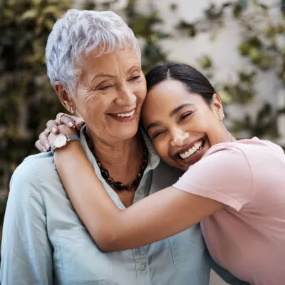 Two Hispanic women hug.