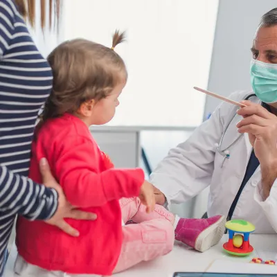 A chid at an appointment with their pediatrician.