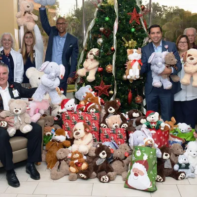 AdventHealth employees and doctors holding up teddy bear donations