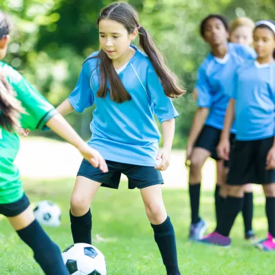 A group of girls playing soccer.