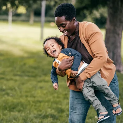 A mom and child playing outside.