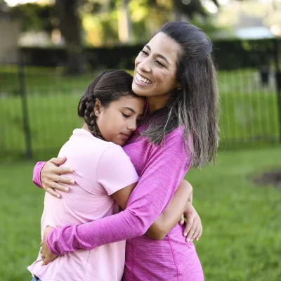 A mother and daughter hugging.