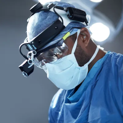 A doctor focused while doing his surgery