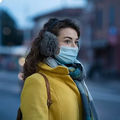 A young woman with winter gear while in her local city.