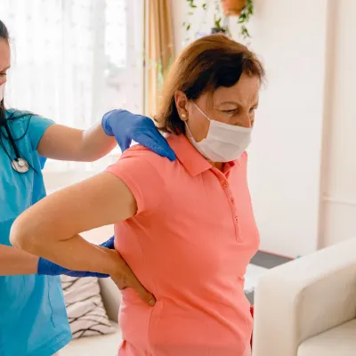 A woman being treated for back pain by her doctor.