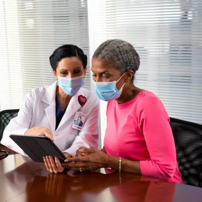 nurse showing patient something on tablet