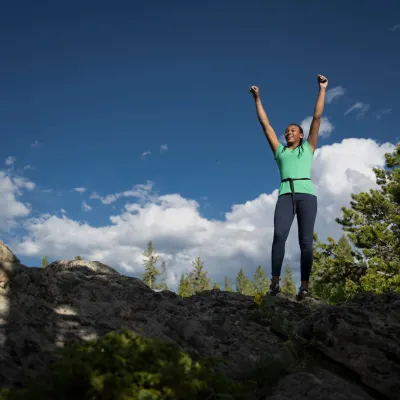 Woman on top of cliff.