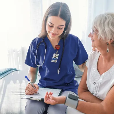 Nurse checking patients blood pressure.