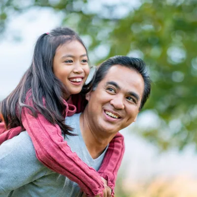 father-carrying-his-daughter-on-his-back