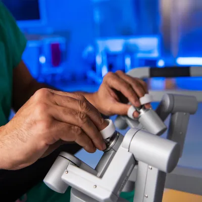 physician using robotic surgery controls