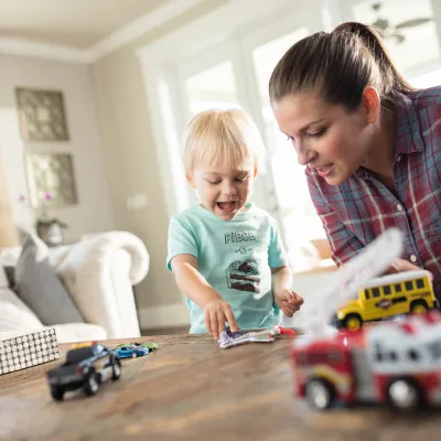Mom playing cars with her son.