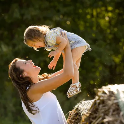 Mother playing with her daughter at the park.