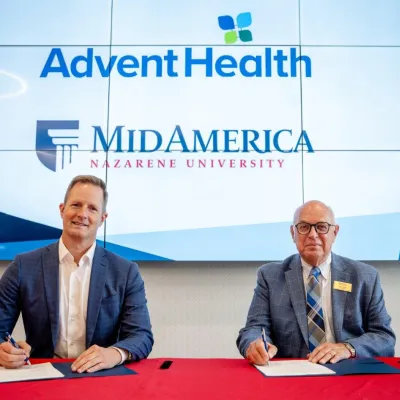 Two men signing documents