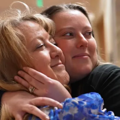 Liver transplant Shelly Kalahar receives a hug.