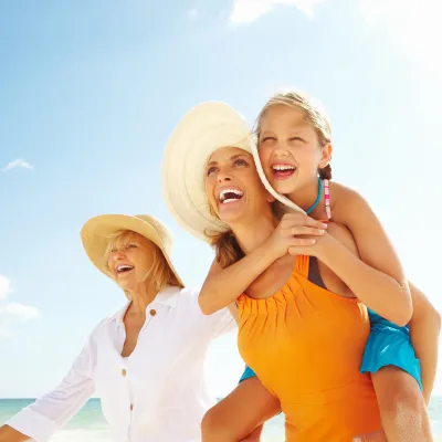 Tri-Generational family of women walking together on the beach