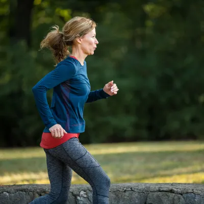A young woman taking a morning run around in the park.