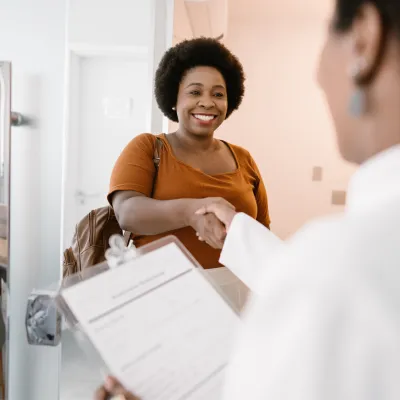 Woman shaking her doctor's hand.