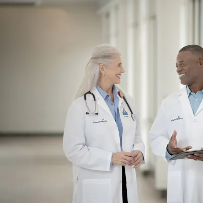 Two doctors talking in a hallway at a hospital
