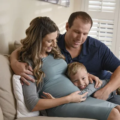 Pregnant woman with her husband and son
