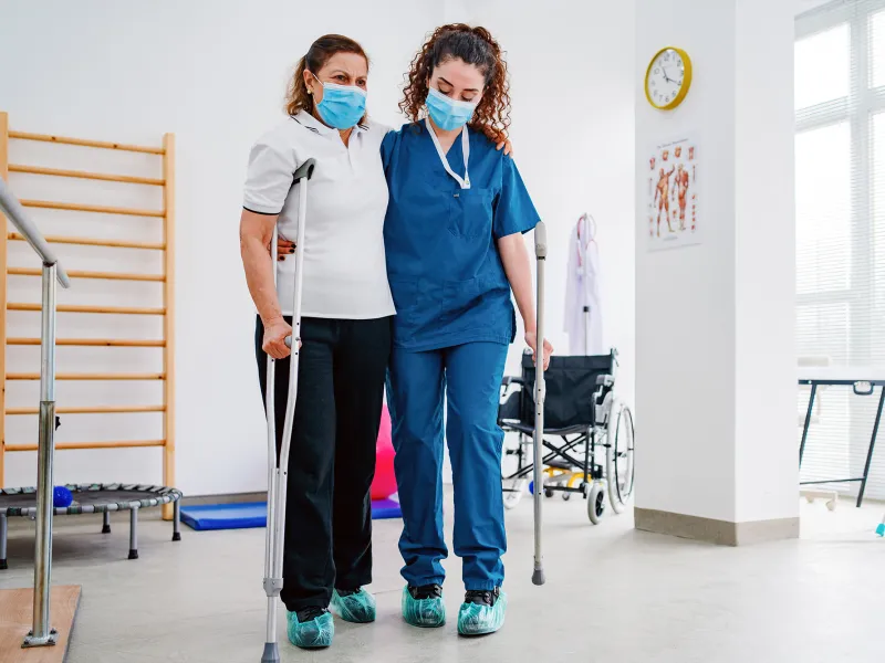 A Physical Therapist Helps a Patient During a Session.