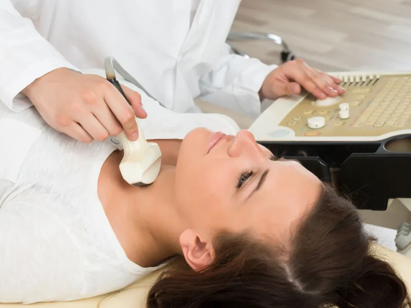 woman getting ultrasound on next