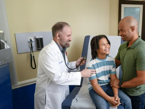 Centra Care Provider Check's a Child Patient's Breathing