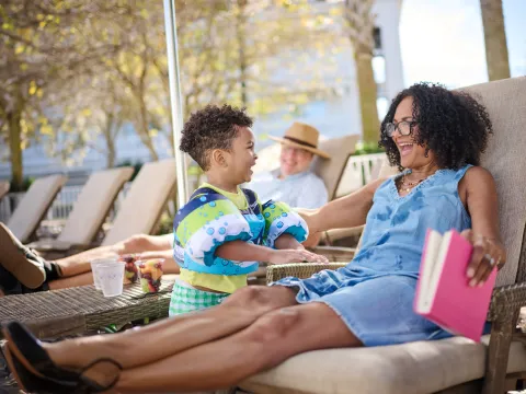 A Little Boy Talks to His Grandmother by the Pool.