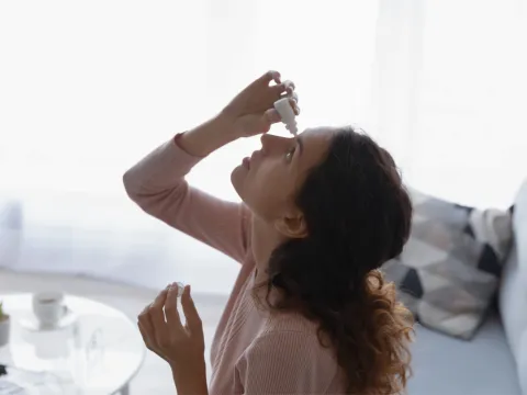 A Woman Gives Herself Eye Drops