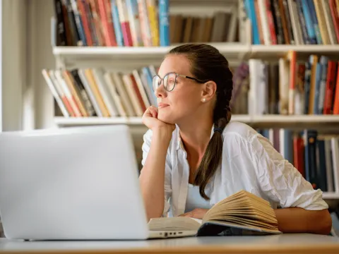 A Teen Stares Out the Window While in the Middle of Her Homework