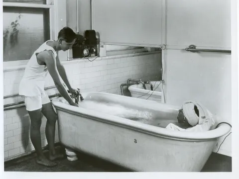 Man with a patient in a hydrotherapy tub.
