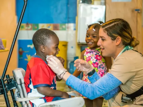 a healthcare worker examining a child