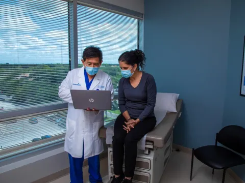 Dr. Sucandy showing a patient slides on his computer