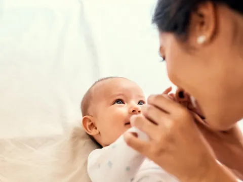 mother kisses a baby's hands peek-a-boo adventhealth gordon