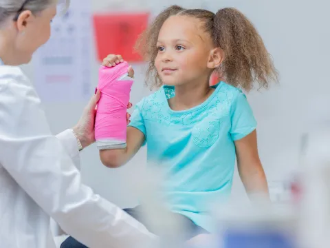 Little girl with a cast on her wrist