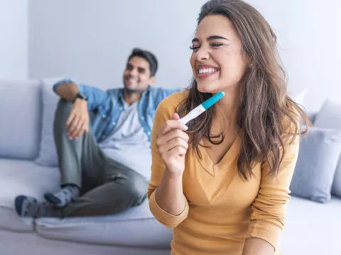 Overjoyed woman reading pregnancy test