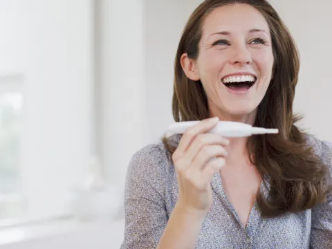 Happy Woman Reading Pregnancy Test