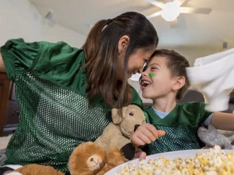 A mother and her young son get ready for the big game.