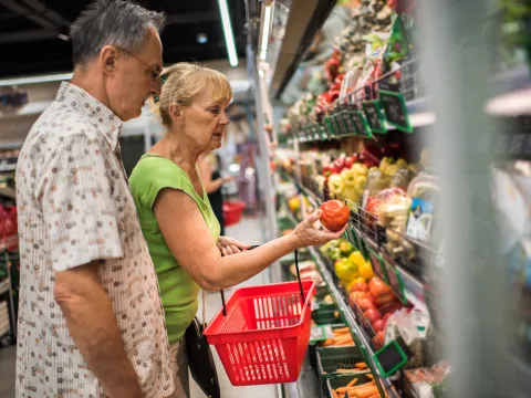 Mature couple buys vegetables